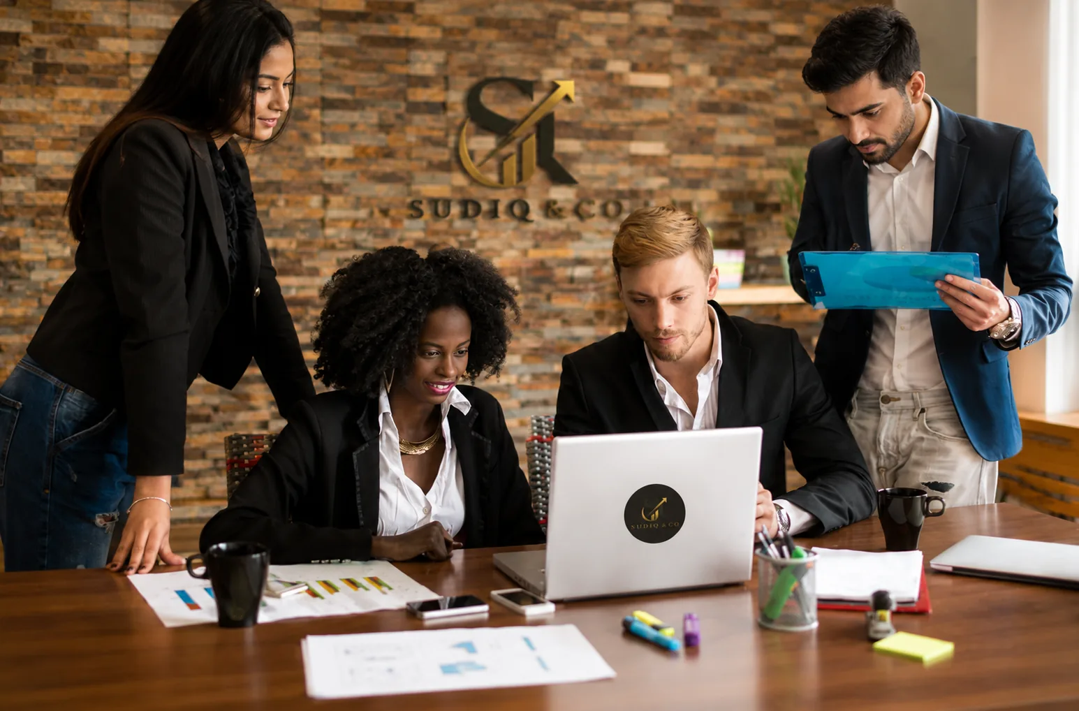 The Sudiq & Co team working with a business owner